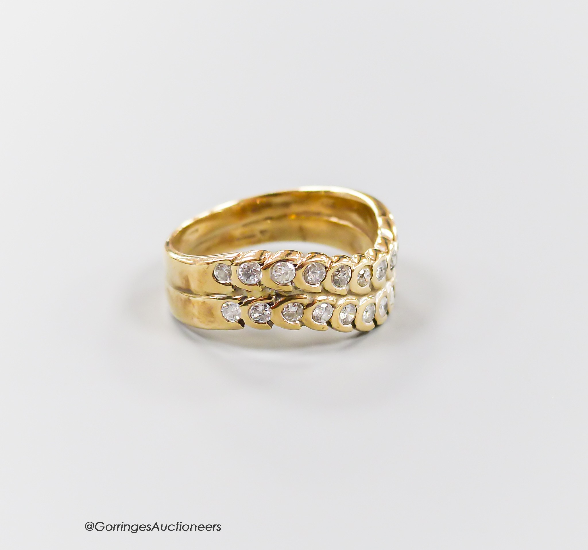 A modern 9ct gold and two row diamond set half hoop ring, size O, gross 4.6 grams.